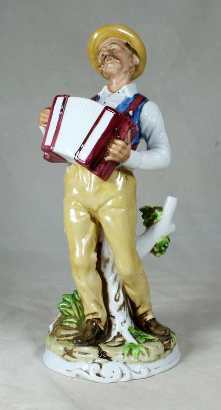 Porcelain old man playing accordion
