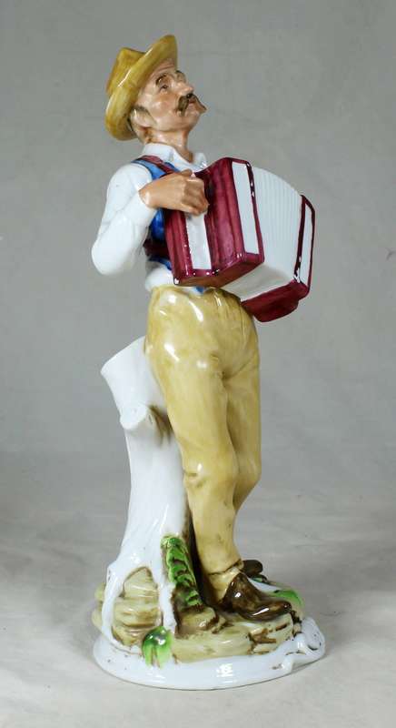 Porcelain old man playing accordion