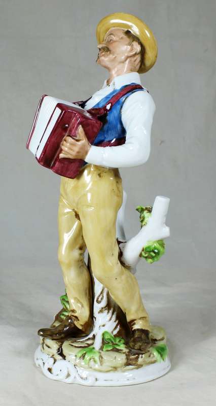 Porcelain old man playing accordion