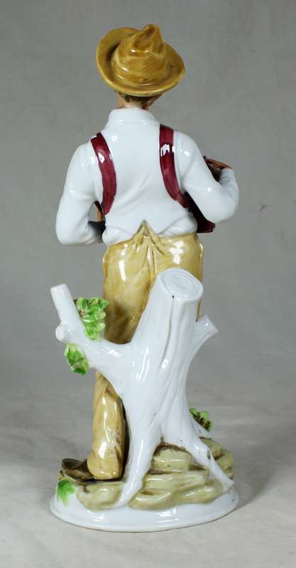 Porcelain old man playing accordion
