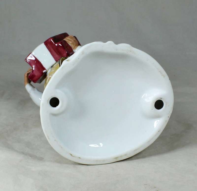 Porcelain old man playing accordion