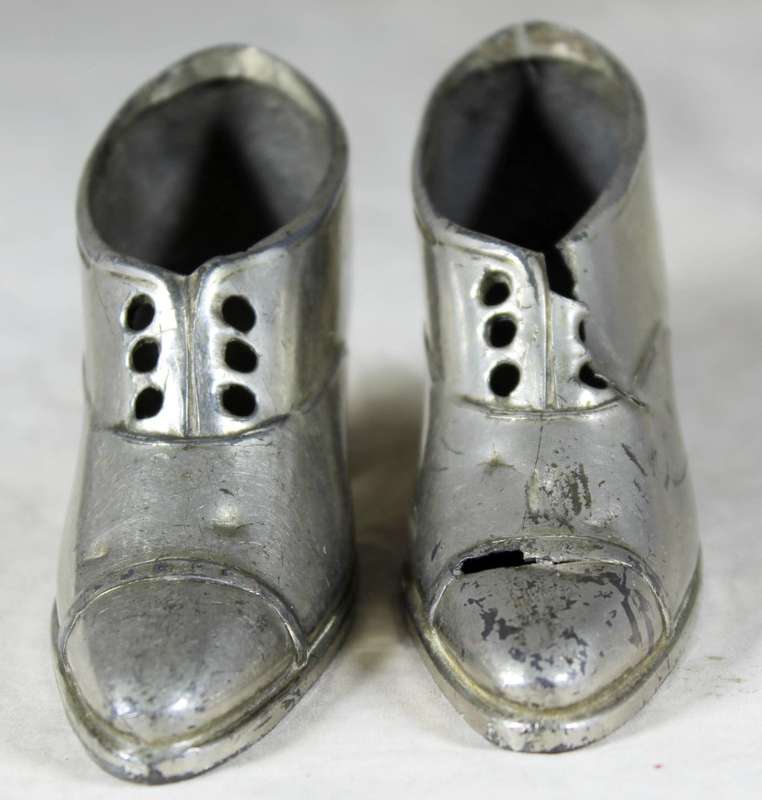 a pair of plated tin boots - made in Germany