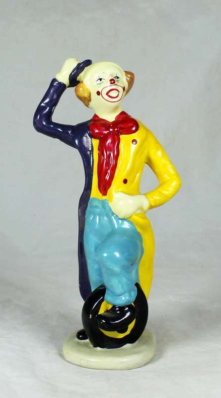 Clown figurine riding a uni-cycle