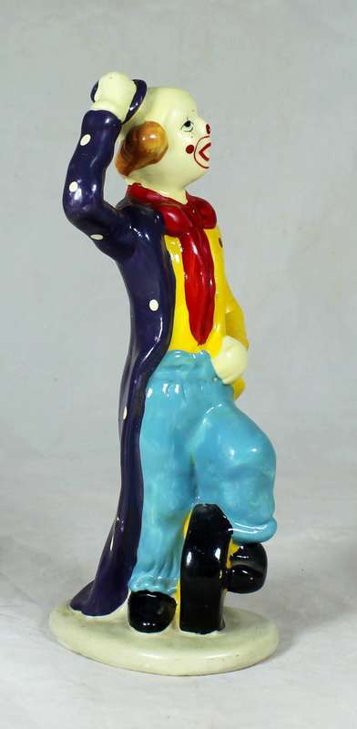 Clown figurine riding a uni-cycle