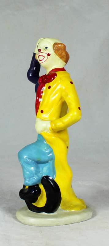 Clown figurine riding a uni-cycle