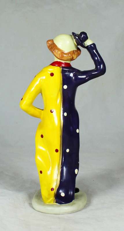 Clown figurine riding a uni-cycle
