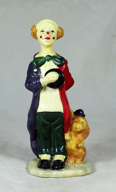 Clown figurine standing to attention with his dog