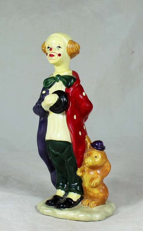 Clown figurine standing to attention with his dog