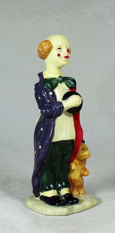 Clown figurine standing to attention with his dog