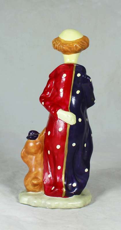 Clown figurine standing to attention with his dog