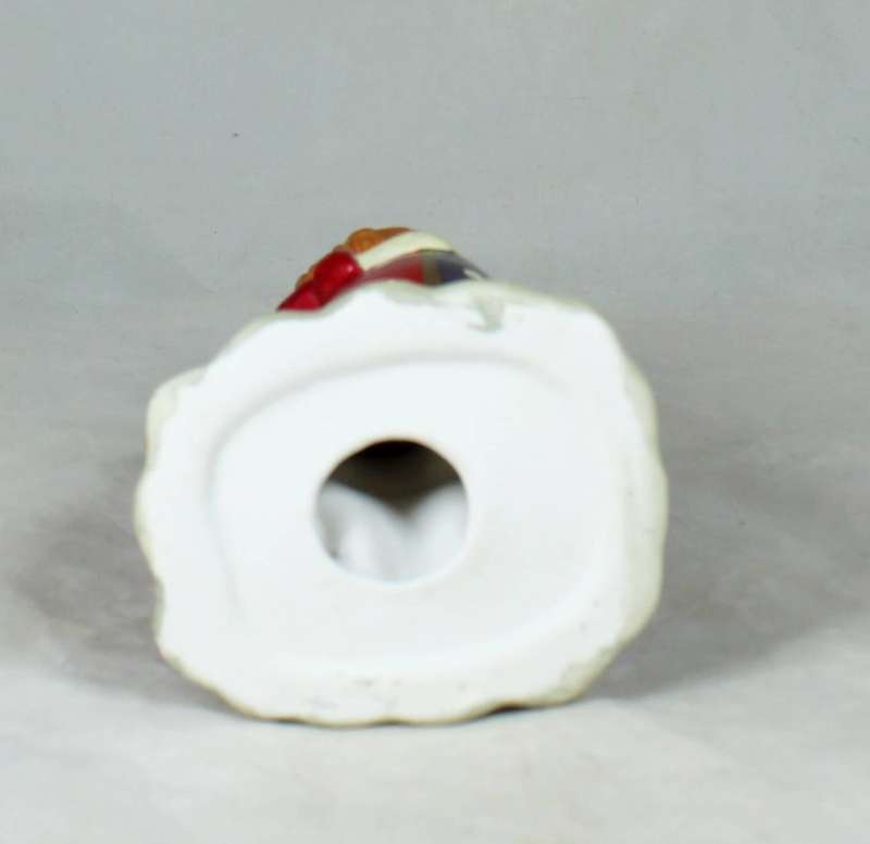 Clown figurine standing to attention with his dog
