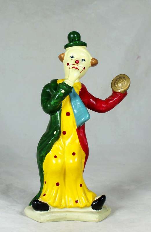 Clown figurine holding a pie