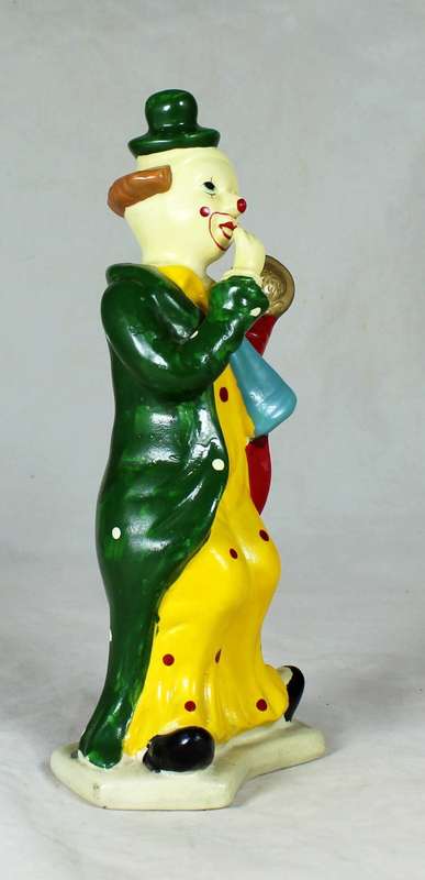 Clown figurine holding a pie