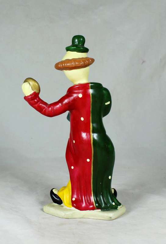 Clown figurine holding a pie