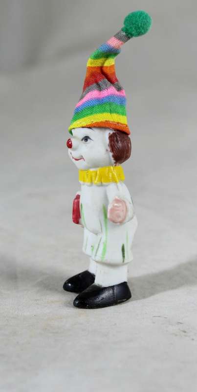 Miniature clown holding books