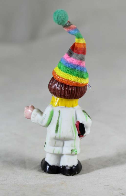 Miniature clown holding books