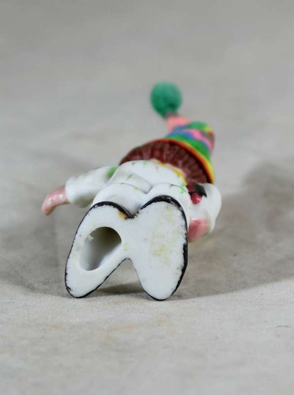 Miniature clown holding books