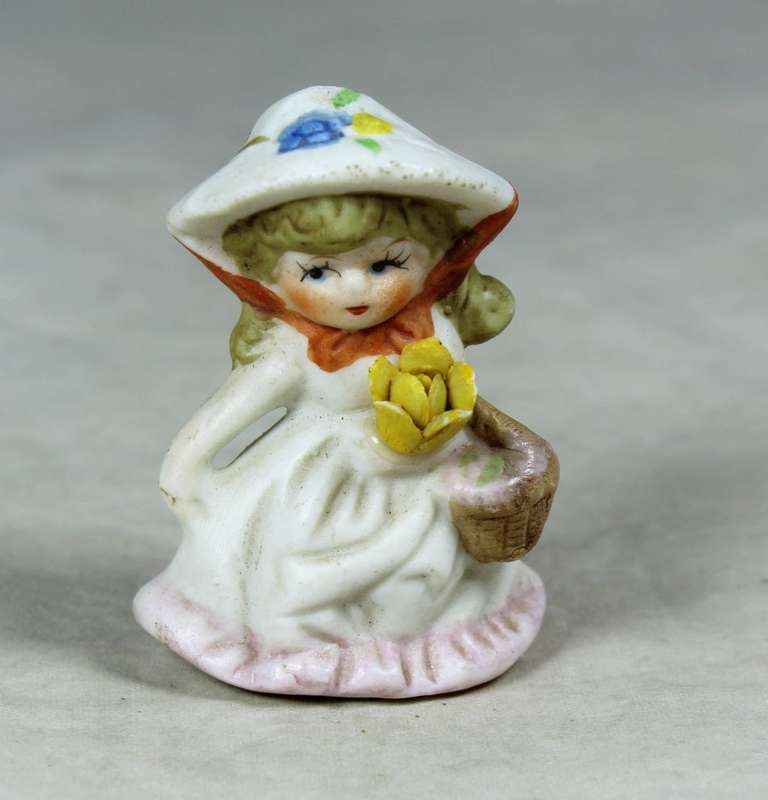 Miniature girl with a basket