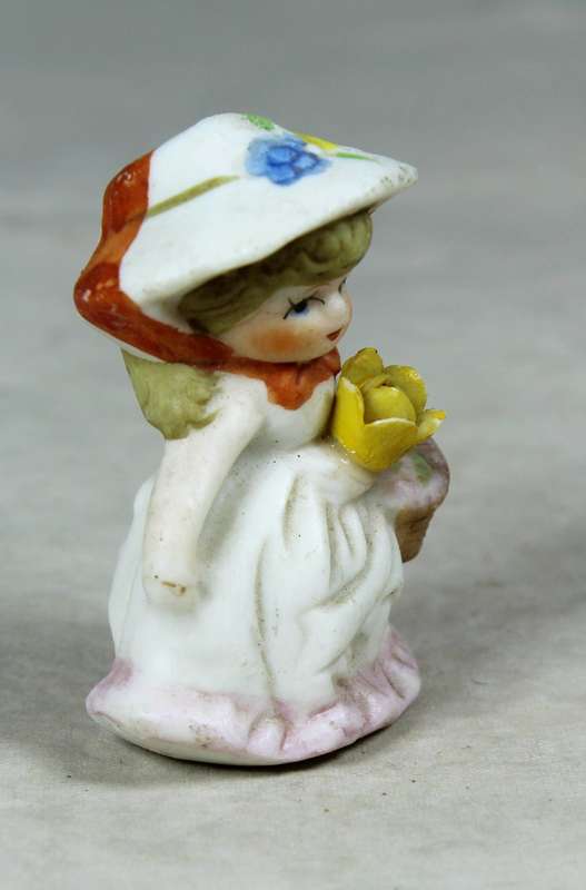 Miniature girl with a basket