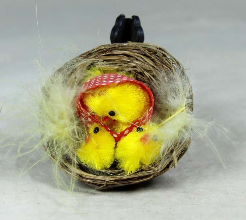 Miniature hen with chicks in a basket