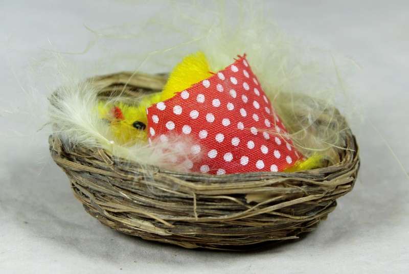 Miniature hen with chicks in a basket