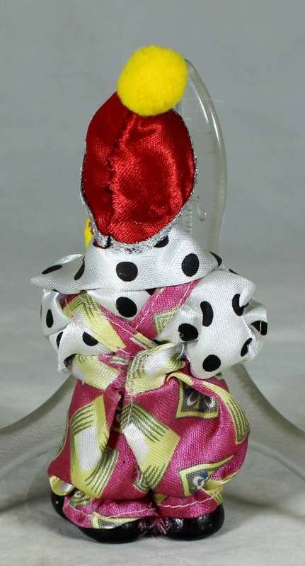 PORCERLAIN CLOWN DRESSED IN A JUMP SUIT WITH A RED HAT