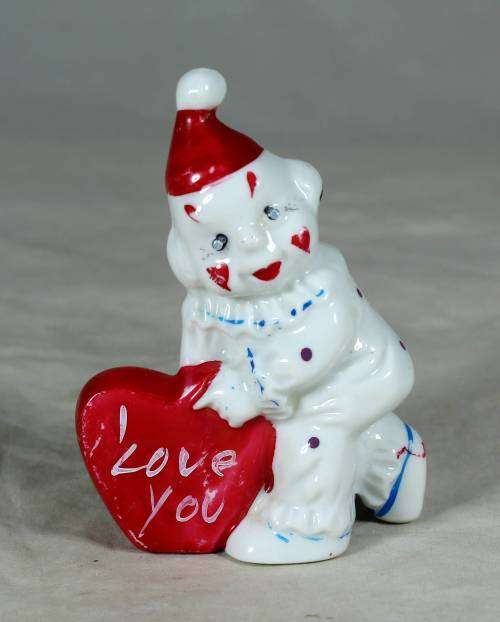 PORCELAIN CLOWN HOLDING AN `I LOVE YOU HEART