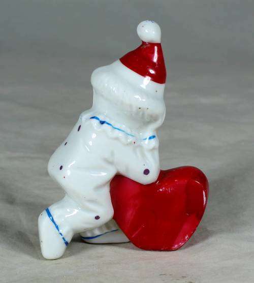 PORCELAIN CLOWN HOLDING AN `I LOVE YOU HEART