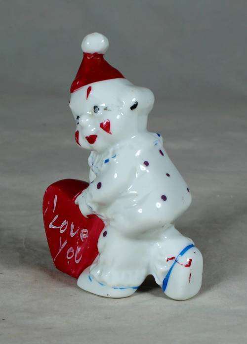 PORCELAIN CLOWN HOLDING AN `I LOVE YOU HEART