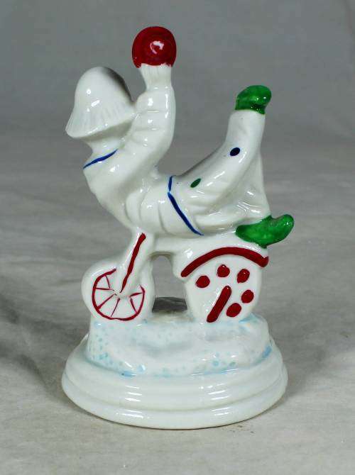Porcelain clown sitting on a tricycle
