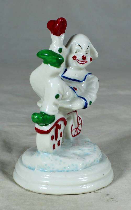 Porcelain clown sitting on a tricycle