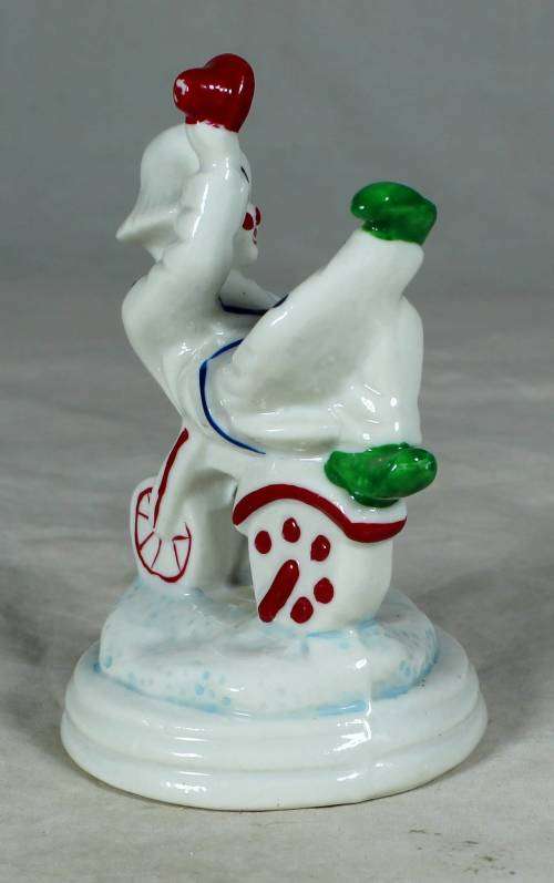 Porcelain clown sitting on a tricycle