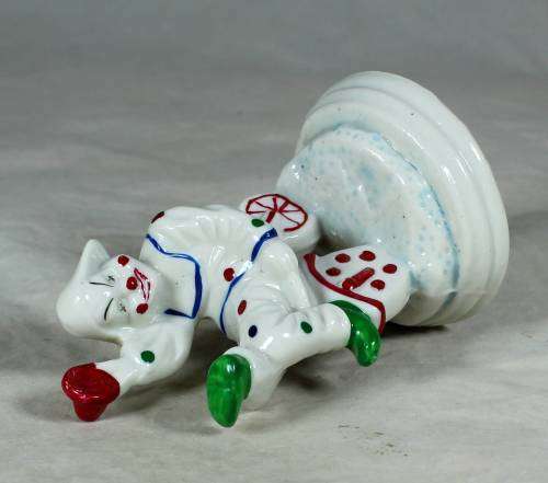 Porcelain clown sitting on a tricycle