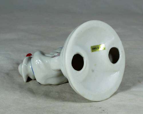 Porcelain clown sitting on a tricycle