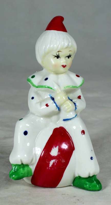 Porcelain clown sitting on a large ball