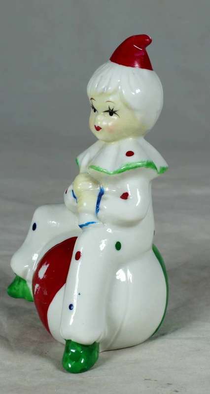 Porcelain clown sitting on a large ball