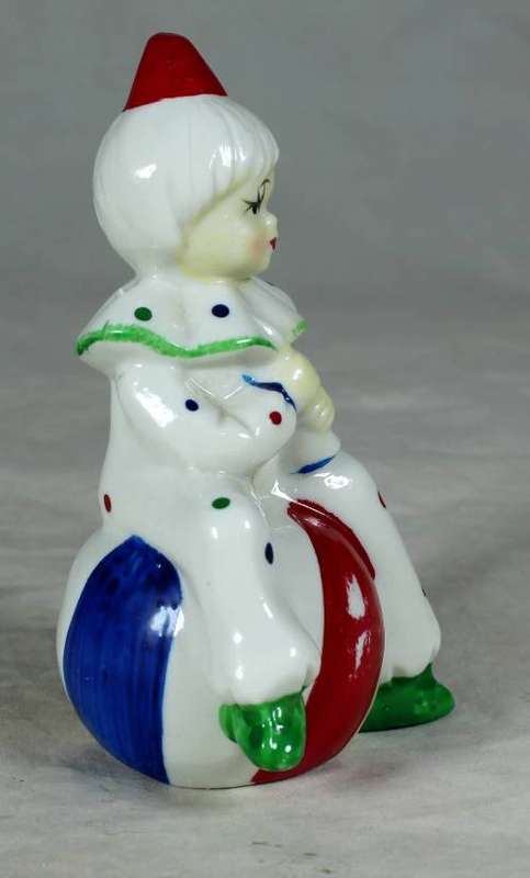 Porcelain clown sitting on a large ball