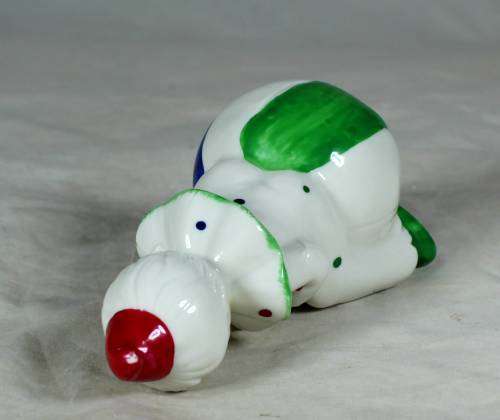 Porcelain clown sitting on a large ball