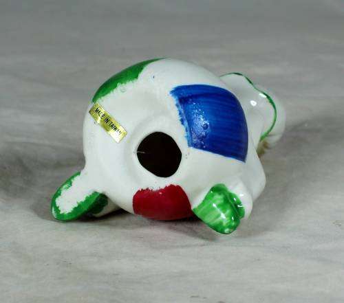 Porcelain clown sitting on a large ball