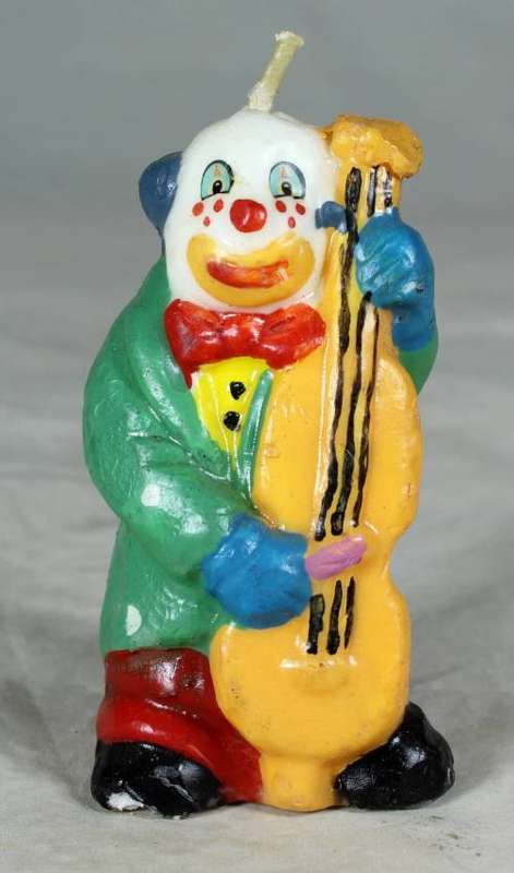 Candle clown playing a base guitar