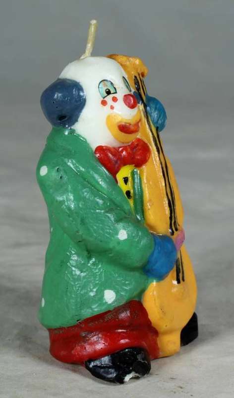 Candle clown playing a base guitar