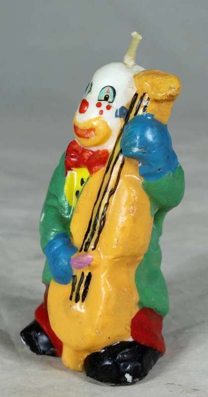 Candle clown playing a base guitar