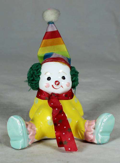 Yellow seated porcelain clown