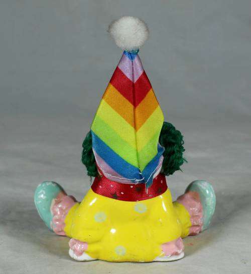 Yellow seated porcelain clown