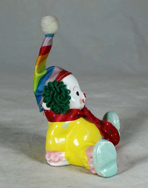 Yellow seated porcelain clown