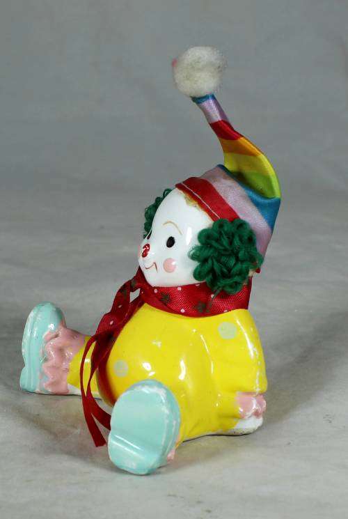 Yellow seated porcelain clown