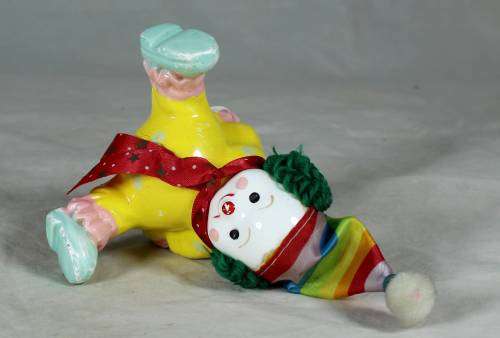 Yellow seated porcelain clown
