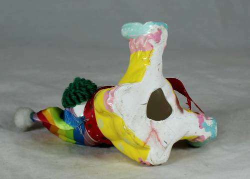 Yellow seated porcelain clown
