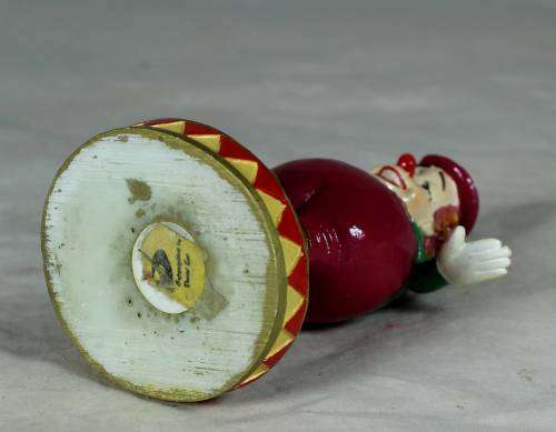 Clown on a stand standing on a ball