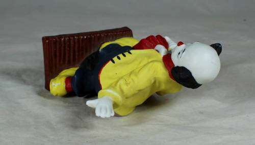 Ceramic clown on a stand striking a pose